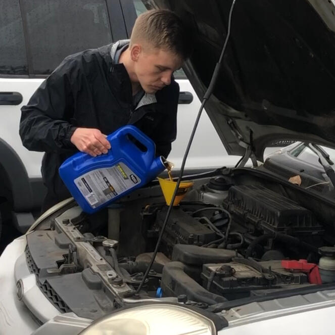 FERN mobile oil change service - photo of man pouring oil into funnel